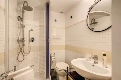 a bathroom with a shower and a sink and a toilet at Navona flat in Rome