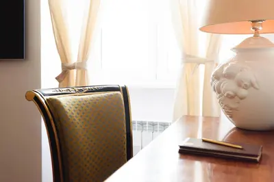 a desk with a chair and a vase on it at EasySleep Vaticano in Rome