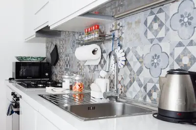 a kitchen counter with a sink and a stove at EasySleep Vaticano in Rome