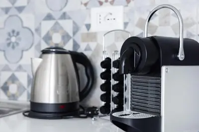 a tea kettle on a counter next to a toaster at EasySleep Vaticano in Rome