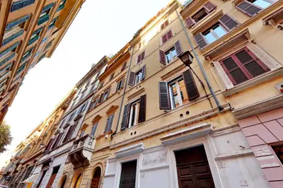 a tall building with many windows on a street at Suite Design Piazza di Spagna in Rome