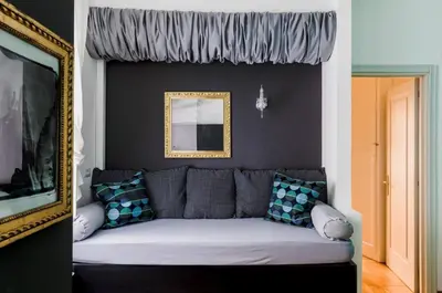 a living room with a couch and a mirror at Suite Design Piazza di Spagna in Rome