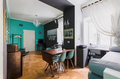 a kitchen and living room with a table and chairs at Suite Design Piazza di Spagna in Rome