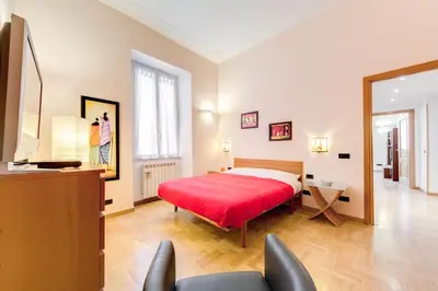 a bedroom with a bed with a red blanket at Diamond Apartments in Rome