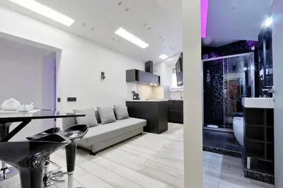 a living room and kitchen with a couch and a table at Diamond Apartments in Rome
