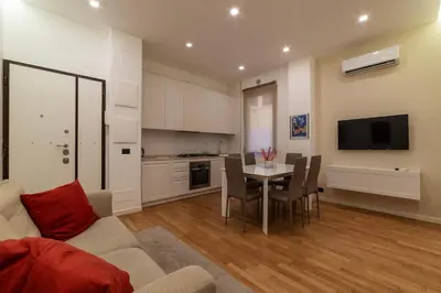 a living room with a couch and a table with chairs at GuestHost - Piazza Bologna Sweet Apartment in Rome