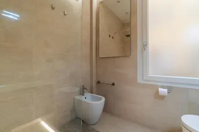 a bathroom with a toilet and a sink and a shower at GuestHost - Piazza Bologna Sweet Apartment in Rome