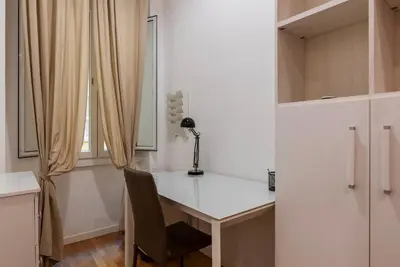 a white desk with a chair and a window at GuestHost - Piazza Bologna Sweet Apartment in Rome
