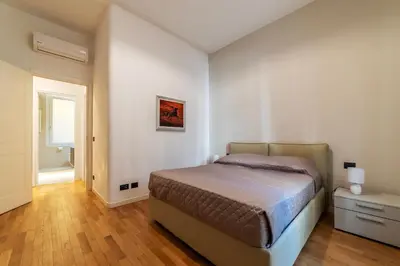 a bedroom with a bed and a bathroom at GuestHost - Piazza Bologna Sweet Apartment in Rome