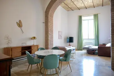 a living room with a table and chairs at Fororomano Luxury in Rome