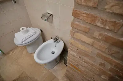 a bathroom with a toilet and a bidet at Fororomano Luxury in Rome