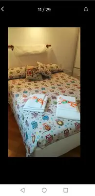 a bed with two pillows on top of it at Il Giardino del Borgo in Rome