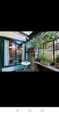 a screened in porch with a table and chairs at Il Giardino del Borgo in Rome