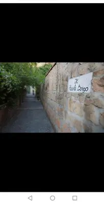 a stone wall with a sign that reads the rock igoco at Il Giardino del Borgo in Rome
