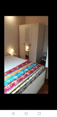 a bed with a colorful blanket on top of it at Il Giardino del Borgo in Rome