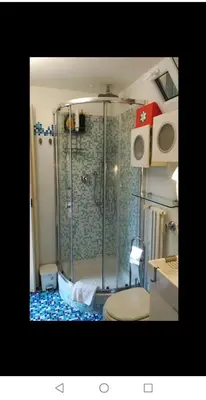 a bathroom with a shower and a toilet in it at Il Giardino del Borgo in Rome