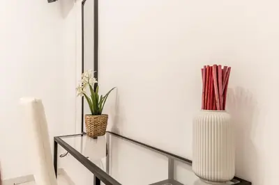 a glass table with two vases on top of it at Petite Maison 19 in Rome