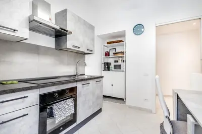 a kitchen with a stove and a sink at Petite Maison 19 in Rome