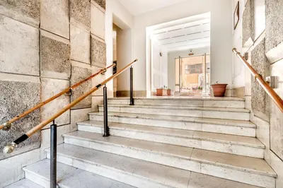 a staircase in a house with a stone wall at Petite Maison 19 in Rome