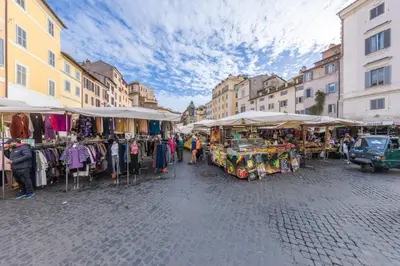 a market in a city with clothes on display at AC21 - Palazzetto Campo de' Fiori in Rome