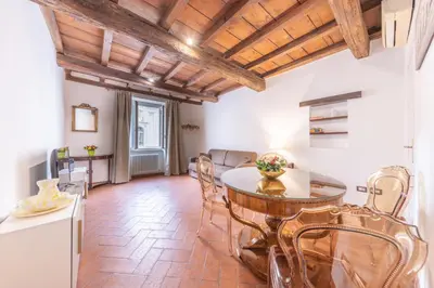 a kitchen and dining room with a table and chairs at AC21 - Palazzetto Campo de' Fiori in Rome