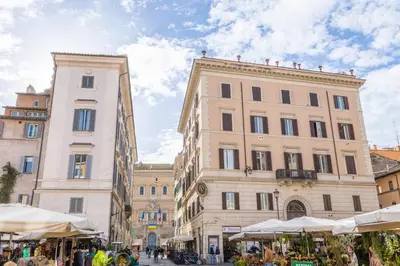 a group of buildings in a street with tents at AC21 - Palazzetto Campo de' Fiori in Rome