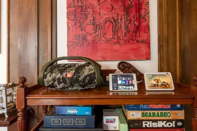 a purse sitting on top of a wooden bench with books at Riad Riari in Rome