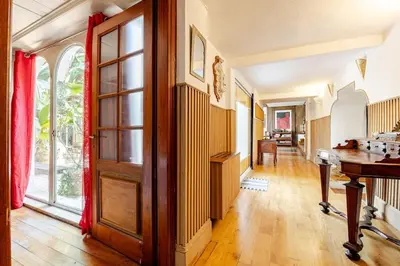 an empty hallway with a wooden door and a table at Riad Riari in Rome