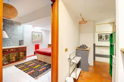 a small room with a bed and a desk at Riad Riari in Rome
