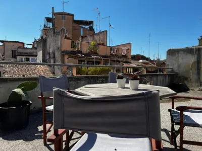 a table and chairs on top of a roof at Trastevere Suite apartment in Rome