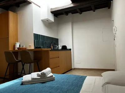 a bedroom with a bed with towels on it at Trastevere Suite apartment in Rome