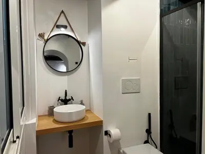 a bathroom with a sink and a mirror and a toilet at Trastevere Suite apartment in Rome