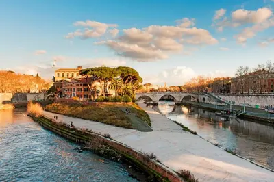 a view of a river with a bridge and buildings at Trastevere Suite apartment in Rome