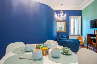 a blue bedroom with a bed with yellow pillows at PgrHome Colosseo 11 BLU in Rome
