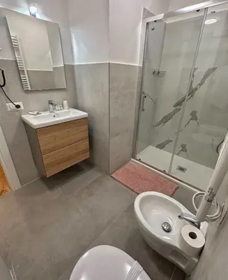 a bathroom with a toilet and a sink and a shower at Santo Apartment in Trastevere in Rome