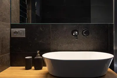 a bathroom with a white bath tub on a wooden counter at San Pietro Guest House in Rome