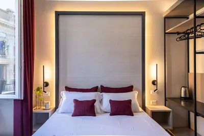 a bedroom with a large white bed with red pillows at Trastevere 143 in Rome