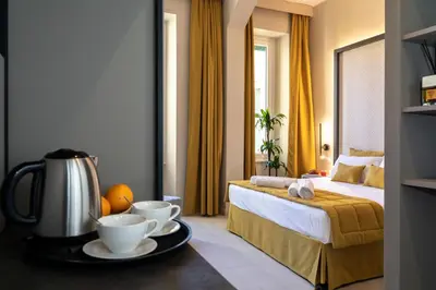 a hotel room with a bed and two cups on a tray at Trastevere 143 in Rome