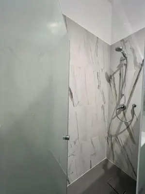 a bathroom with a shower with a glass door at Campo de’ Fiori Rooftop Apartment in Rome
