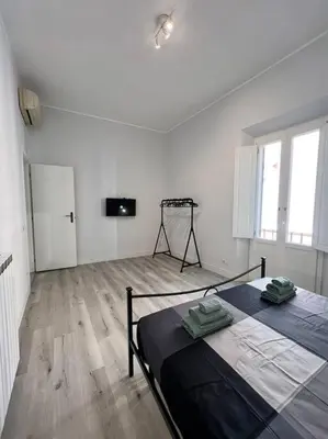 a room with two beds and a television in it at Campo de’ Fiori Rooftop Apartment in Rome