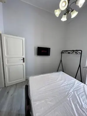 a bedroom with a bed and a clock on the wall at Campo de’ Fiori Rooftop Apartment in Rome