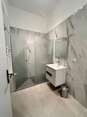 a bathroom with a shower and a sink and a mirror at Campo de’ Fiori Rooftop Apartment in Rome