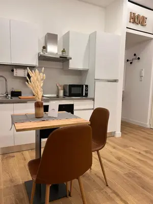 a kitchen with a table and chairs in a kitchen at SIRI VATICAN LOFT - Design House Rome in Rome