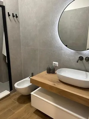 a bathroom with a white sink and a mirror at SIRI VATICAN LOFT - Design House Rome in Rome