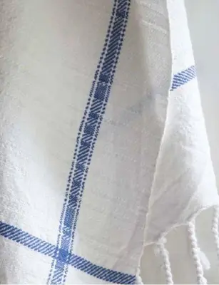 a white towel with blue stripes on it at Piazza di Spagna Home - Family Apartment in Rome