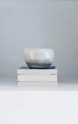 a bowl is sitting on top of two books at Piazza di Spagna Home - Family Apartment in Rome