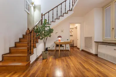 a living room with stairs and a table with a plant at Welcome to Pantheon in Rome