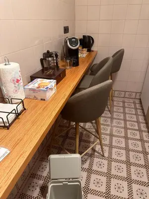 a table in a room with two chairs and a counter at Welcome to Pantheon in Rome