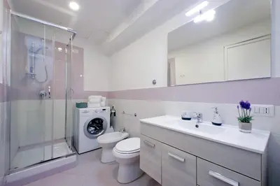 a bathroom with a toilet and a sink and a shower at Porta San Giovanni Suite in Rome