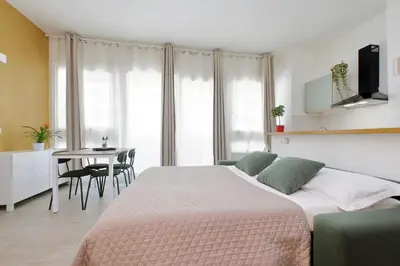 a bedroom with a bed and a table with chairs at Porta San Giovanni Suite in Rome